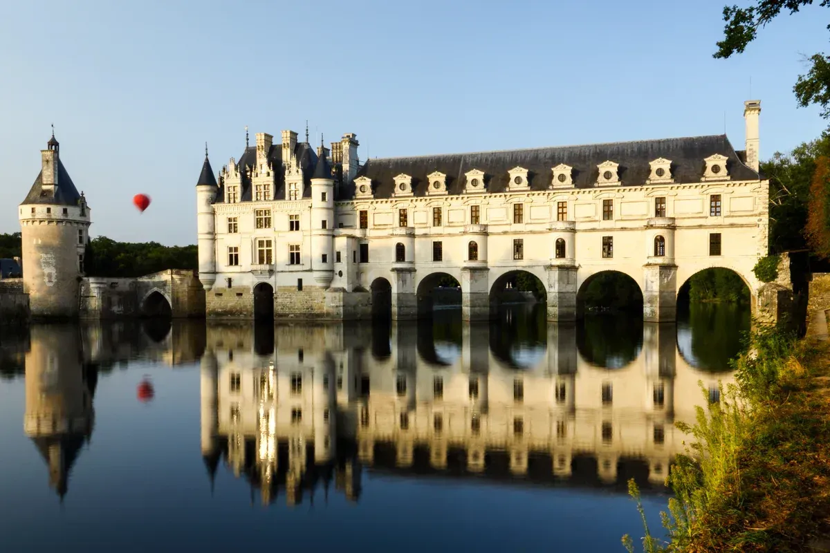 Château de Chenonceau on its arches over the Cher at sunrise, a highlight of Loire Valley wine and castle tours